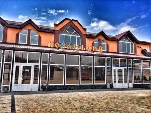 a building with a sign on the front of it at Готель Козацький in Zvenyhorodka