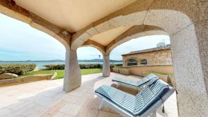 an outdoor patio with a table and chairs on a building at Villetta Ginepri in Cannigione