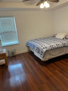 a bedroom with a bed and a ceiling fan at Cozy LeHigh Extended Stay in Fort Myers