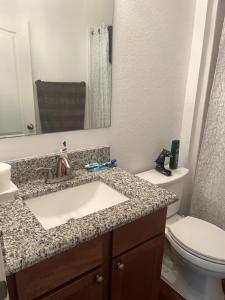 a bathroom with a sink and a toilet at Cozy LeHigh Extended Stay in Fort Myers