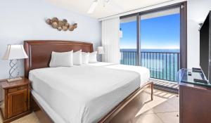 a bedroom with a large bed and a balcony at One Seagrove Place 1505 in Santa Rosa Beach