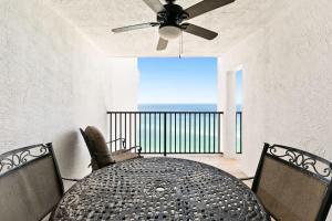 a dining room with a table and a ceiling fan at One Seagrove Place 1505 in Santa Rosa Beach