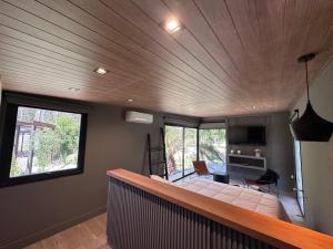 a bedroom with a bed and a living room at LÜN Lodges in Chacras de Coria