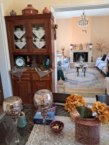 a living room with wine glasses on a table at Villa Excelsior in Korinthos +21 photos