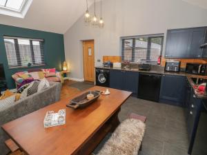 a living room with a couch and a table at Otter's Rest in Droitwich