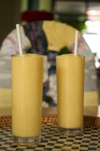 two glasses of orange juice sitting on a table at Stefanie Grace Inn in Loboc