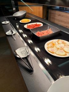 a counter in a kitchen with plates of food at Hotel Teruel in Vinarós +46 photos