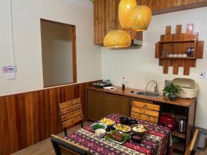 a kitchen with a table with food on it at Alu Homestay SaPa in Sapa