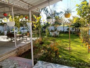 a garden with tables and chairs and potted plants at GC Farms in Ayodhya