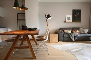 a living room with a table and a couch at Sun Lodge Schladming by Schladming-Appartements in Schladming