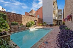 a swimming pool in the courtyard of a house at Grenoble House in New Orleans