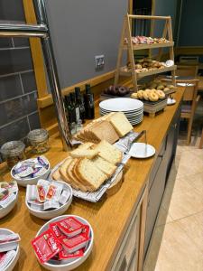 a counter with bread and other food on it at Hotel Teruel in Vinarós