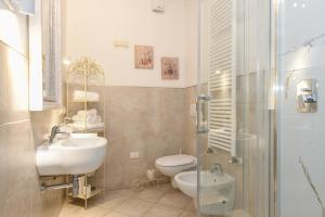 a bathroom with a sink and a toilet and a shower at Le Rêve - Lake view rooms in Sirmione +107 photos