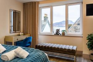 a bedroom with a bed and a window with a view at Arran Shores Luxury Shorefront Penthouse Suite 11 in Lamlash
