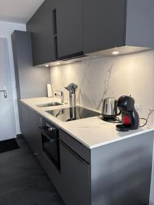 a kitchen with a sink and a counter top at Studio rénové Ovronnaz chalet Orion in Ovronnaz