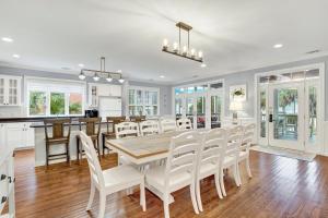 a kitchen and dining room with a table and chairs at Front Porch Lounge in Tybee Island