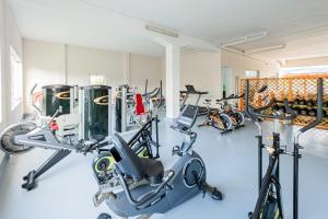 a gym with several bikes in a room at Lena Village - Hotel and Spa in Mortágua