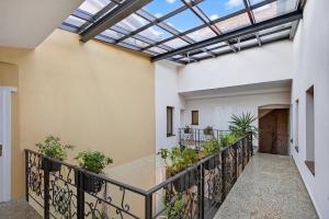 an indoor balcony with a skylight and plants at Schloss Haus Boutique in Braşov