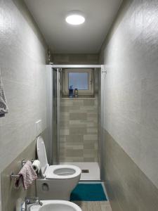 a small bathroom with a toilet and a shower at Dimora Coacci in Grottammare +17 photos