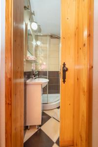 a bathroom with a sink and a toilet and a mirror at Our House Apartments in Kolašin +51 photos
