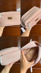 a pink suitcase being held up by a hand at JMATS Homestay in Dipolog +1 photo