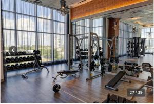 a gym with several treadmills and machines in a room with windows at Hyde house 3507 AL MAR in Hollywood