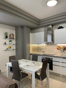 a kitchen with a white table and chairs in it at Dimora Coacci in Grottammare