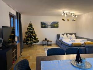 a living room with a christmas tree and a couch at Jubiläum Apartment in Bad Ischl