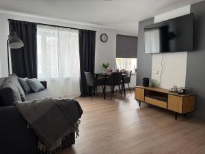 a living room with a couch and a table at Central Apartment in Jelgava