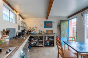 a kitchen with a table and a dining room at Amrita Shala in Colares