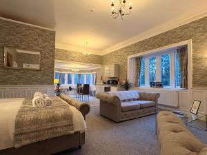 a bedroom with a bed and a living room at Rossal House Apartments in Inverness