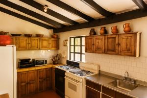 a kitchen with wooden cabinets and a stove top oven at Finca La Mara in Tibasosa
