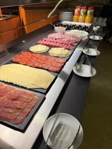 a buffet line with different types of meats and cheese at Hotel Teruel in Vinarós