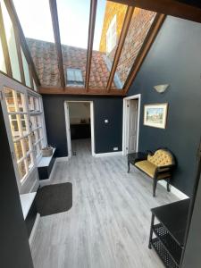 an attic room with a couch and a roof at Old Swan Cottage in Great Massingham