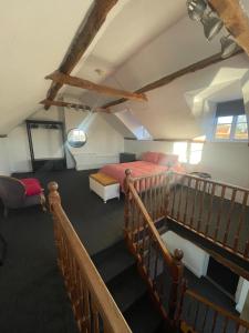 a attic bedroom with a bed and a staircase at Old Swan Cottage in Great Massingham