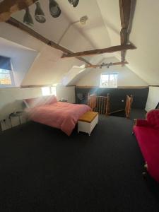 a bedroom with a large bed in a room at Old Swan Cottage in Great Massingham