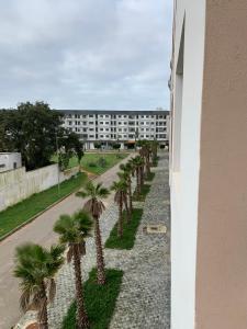a row of palm trees in front of a building at bel appartement juste à côté de McDonald's in Kenitra