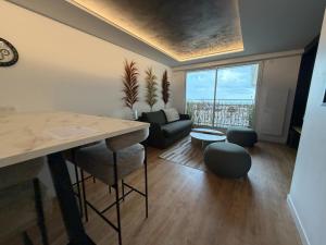 a living room with a couch and a table at Appartement d'architecte face à la mer in Les Sables-d'Olonne