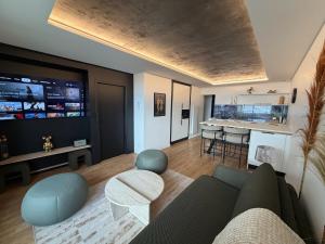 a living room with a couch and a table at Appartement d'architecte face à la mer in Les Sables-d'Olonne