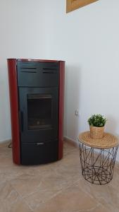a black oven in a room with a table at Casa Anibal in Burón +46 photos