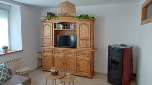 a large wooden entertainment center with a television in a living room at Casa Anibal in Burón