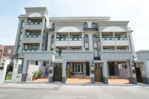 a large white building with a lot of windows at Taiping Homestay in Taiping