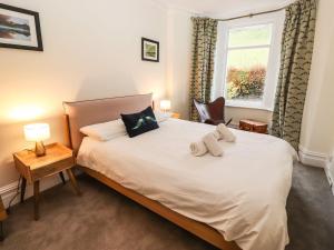 a bedroom with a bed with two towels on it at Waterhead Cottage in Ambleside