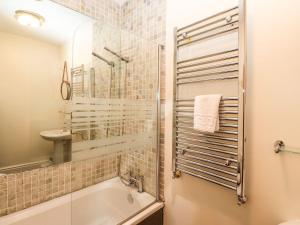 a bathroom with a tub and a sink at Waterhead Cottage in Ambleside