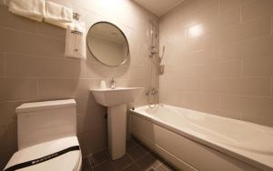 a bathroom with a toilet and a sink and a tub at Hotel Yam Bucheon Station in Bucheon +29 photos