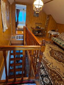 a room with a staircase and a living room at Edelweiss Ilinca in Zărneşti