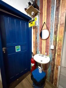 a bathroom with a blue door and a sink at Pinheiros Hostel & Food in São Paulo +73 photos