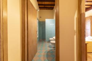 a bathroom with two toilets and a blue tile floor at Villa Montarioso in Siena +62 photos
