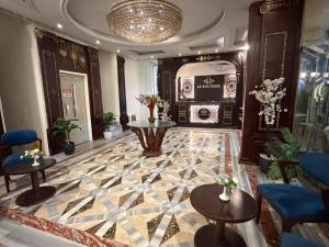 a lobby with a marble floor with tables and chairs at La Boutique Residence in Hurghada