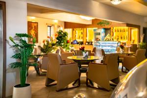 a restaurant with chairs and a table and a dining room at Hotel Lubumbashi in Lubumbashi